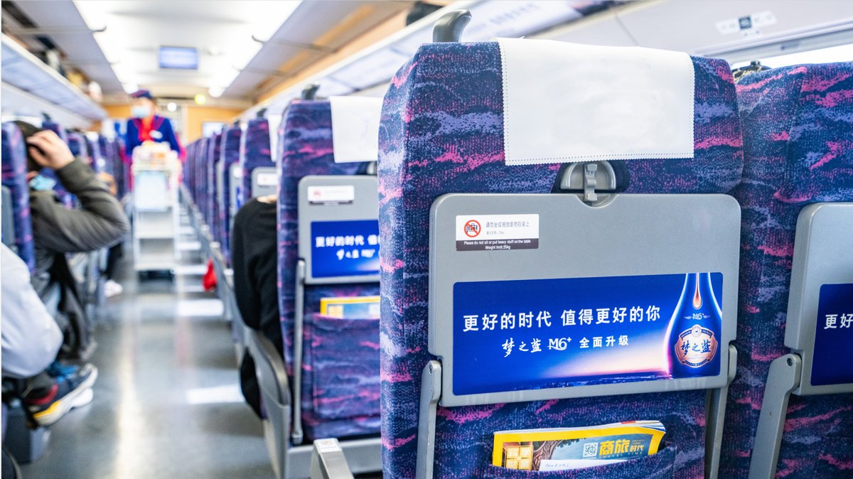 Tray table sticker advertising inside a high-speed railway train carriage